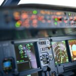 Close-up view of airplane cockpit instrumentation with modern digital displays.